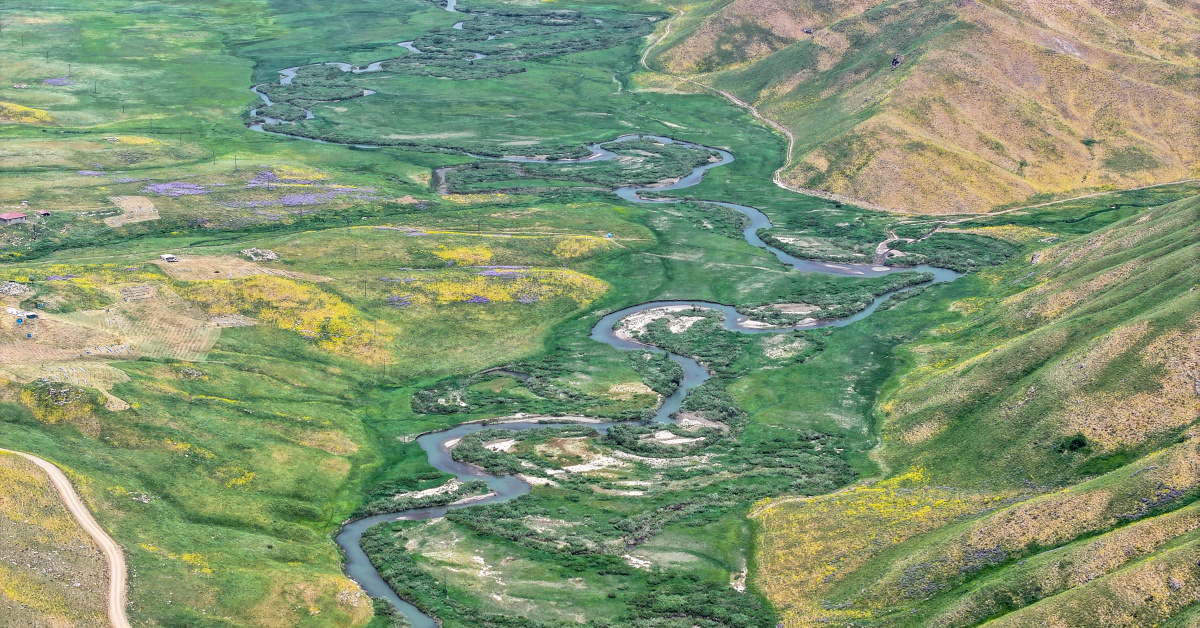 Captivating with its meanders, meadows, and glacial lakes
